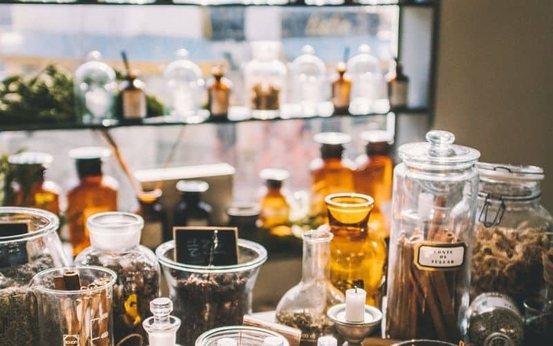 a collection of amber medicine and herb bottles with various tinctures