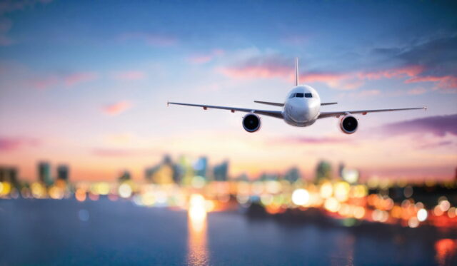 Plane flying to the north american refugee health conference 2025 with the sun setting in the distance