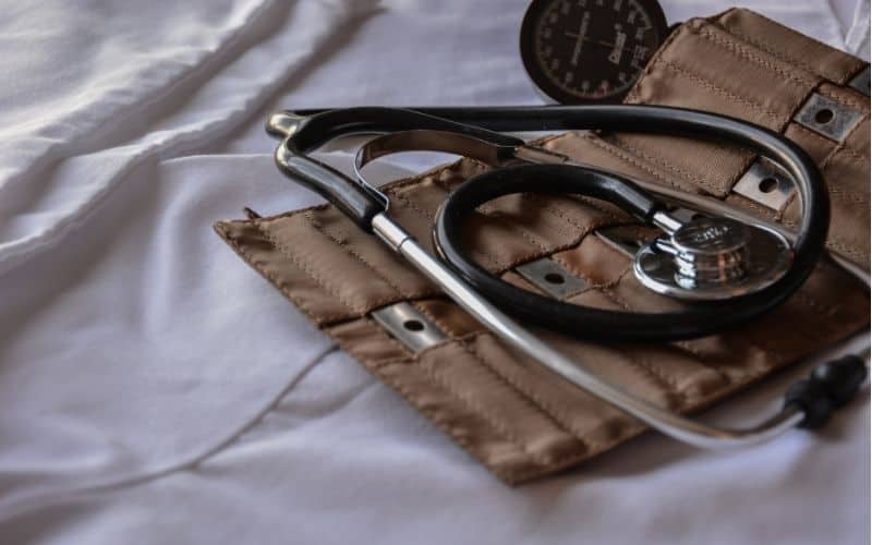 A stethoscope and bandage on a hospital bed