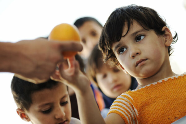 Refugee children receiving food